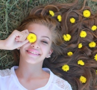 Mdchen mit Blumen im Haar auf der Wiese liegend